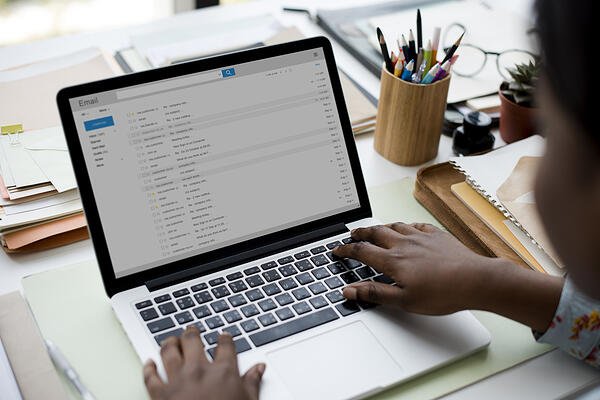checking email on laptop